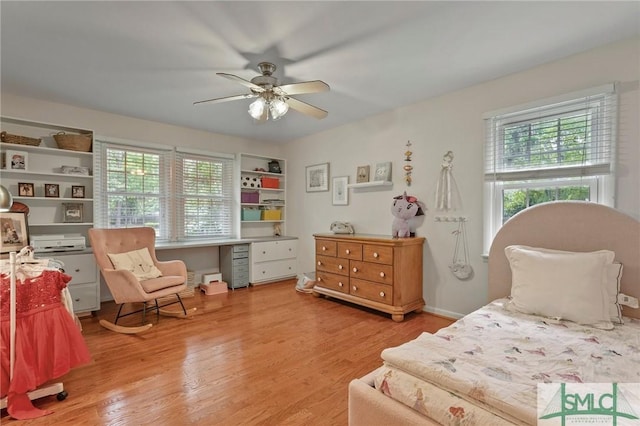 bedroom with a ceiling fan and light wood-style flooring