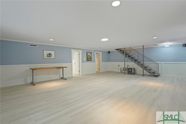 unfurnished living room featuring recessed lighting, visible vents, ornamental molding, wainscoting, and wood finished floors