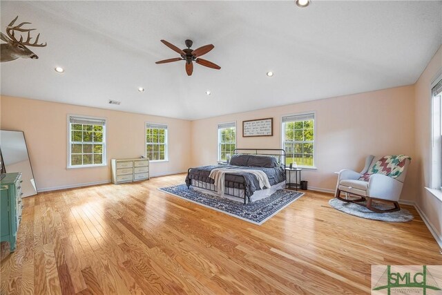 229 Golden Dr, Rincon, GA 31326 - bedroom featuring visible vents, light wood-style flooring, vaulted ceiling, and multiple windows