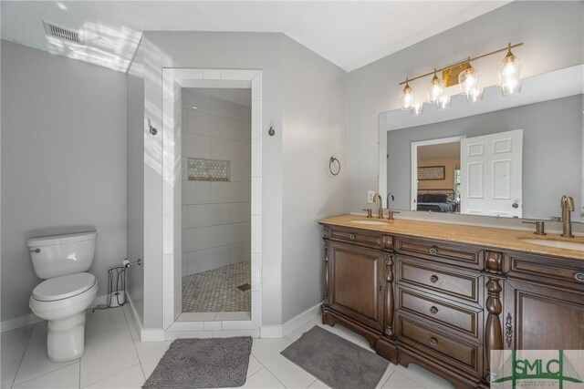 229 Golden Dr, Rincon, GA 31326 - ensuite bathroom featuring baseboards, a tile shower, toilet, and a sink