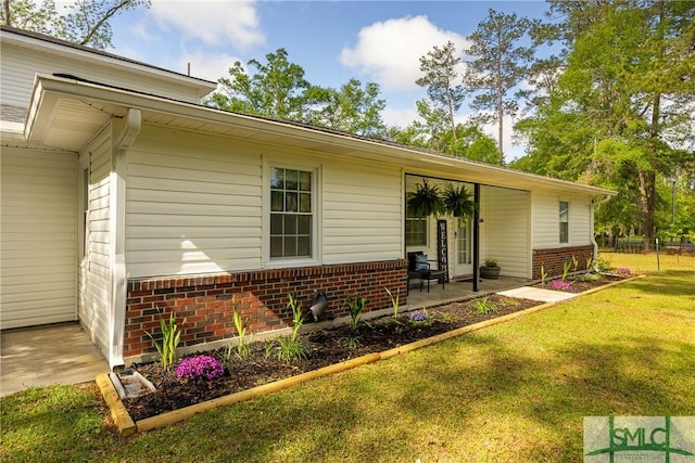 229 Golden Dr, Rincon, GA 31326 - rear view of property with a yard and brick siding