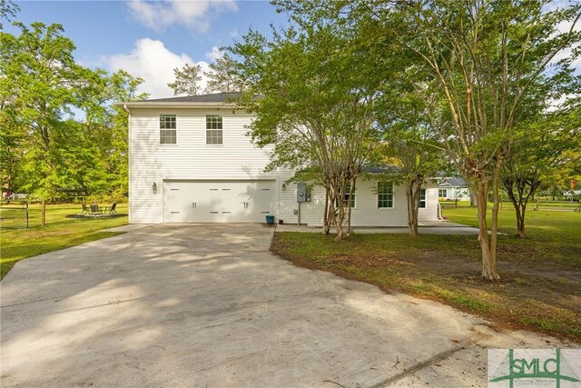 229 Golden Dr, Rincon, GA 31326 - view of front of house with a garage, a front lawn, and driveway