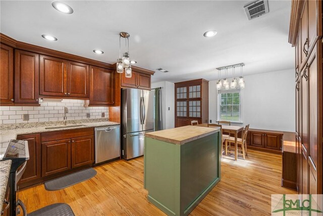 229 Golden Dr, Rincon, GA 31326 - kitchen featuring tasteful backsplash, butcher block countertops, stainless steel appliances, a sink, and visible vents