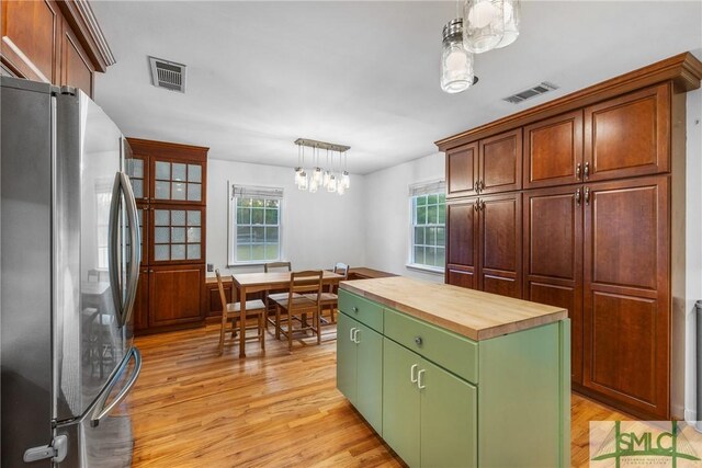 229 Golden Dr, Rincon, GA 31326 - kitchen with butcher block countertops, freestanding refrigerator, light wood-style floors, visible vents, and a notable chandelier