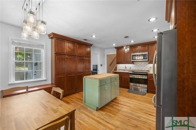 229 Golden Dr, Rincon, GA 31326 - kitchen featuring light wood finished floors, stainless steel appliances, visible vents, a kitchen island, and wooden counters