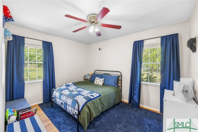 229 Golden Dr, Rincon, GA 31326 - bedroom featuring wood finished floors, ceiling fan, baseboards, and multiple windows