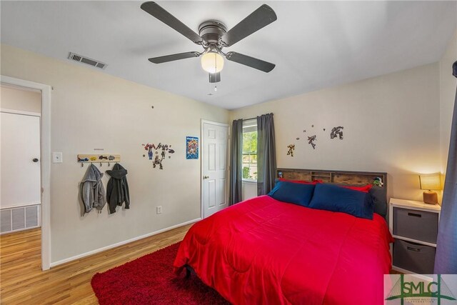229 Golden Dr, Rincon, GA 31326 - bedroom with wood finished floors, visible vents, ceiling fan, and baseboards