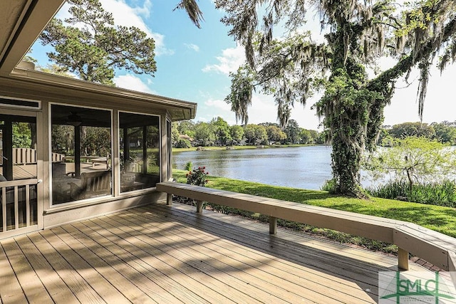 wooden deck featuring a water view and a sunroom