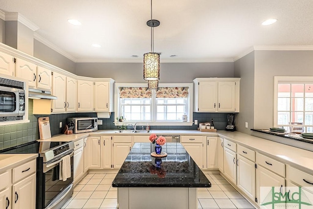 kitchen with under cabinet range hood, light tile patterned floors, a sink, and appliances with stainless steel finishes