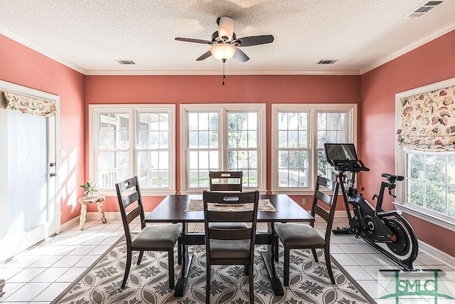 dining space featuring visible vents, a textured ceiling, and a ceiling fan