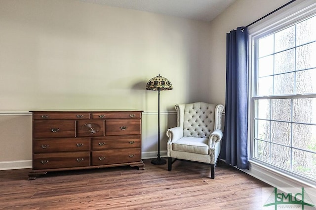 living area featuring dark wood-style floors and baseboards