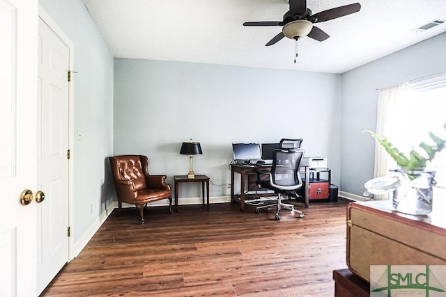 office featuring wood finished floors, baseboards, a ceiling fan, and visible vents