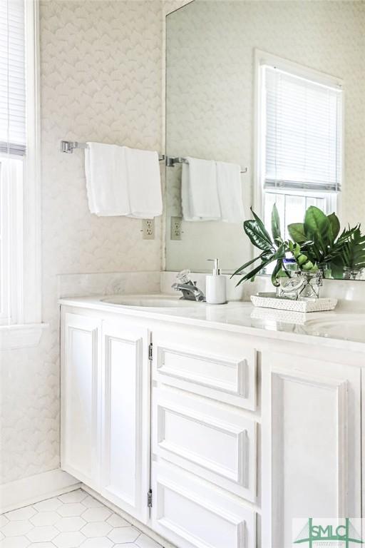 bathroom featuring a sink, double vanity, and tile patterned flooring