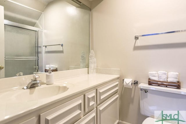 full bathroom featuring toilet, vanity, baseboards, and a shower stall