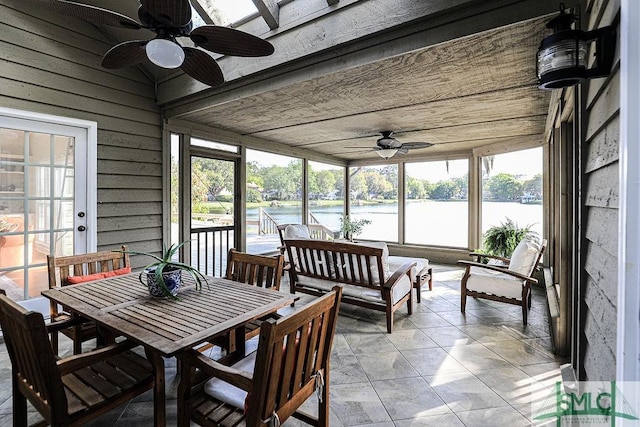 sunroom / solarium featuring a water view, an outdoor living space, and a ceiling fan