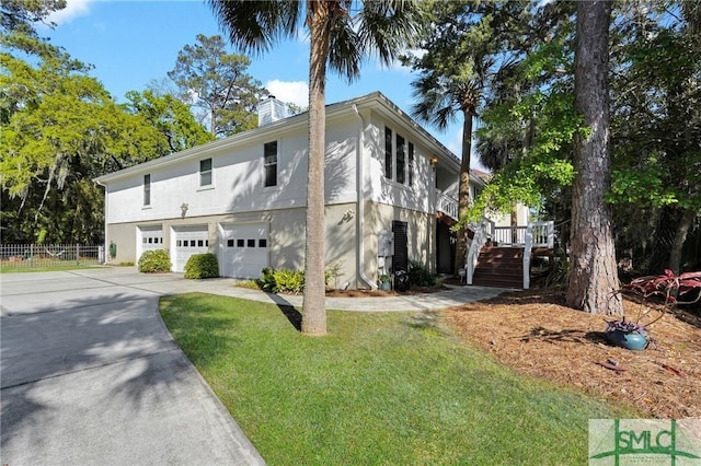 116 Brevard Ct, Savannah, GA 31410 - view of front of home with stairway, stucco siding, concrete driveway, and a chimney