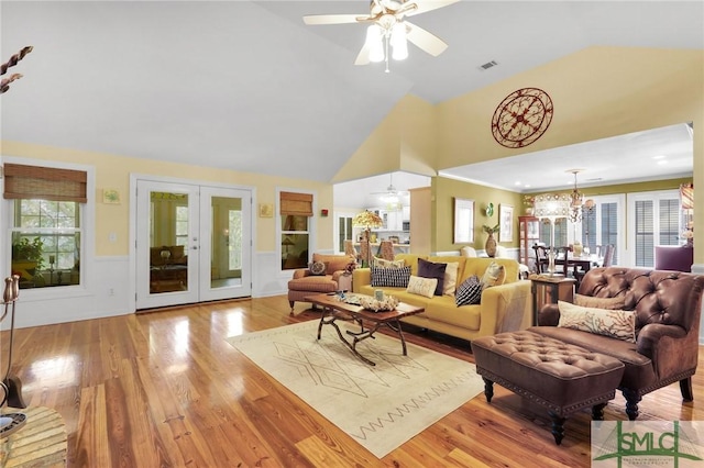 116 Brevard Ct, Savannah, GA 31410 - living room with a ceiling fan, high vaulted ceiling, wainscoting, a chandelier, and light wood-style flooring