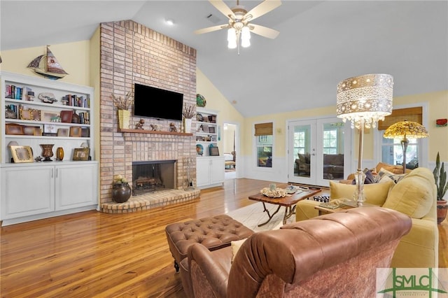 116 Brevard Ct, Savannah, GA 31410 - living room featuring a fireplace, wood finished floors, ceiling fan, high vaulted ceiling, and a chandelier