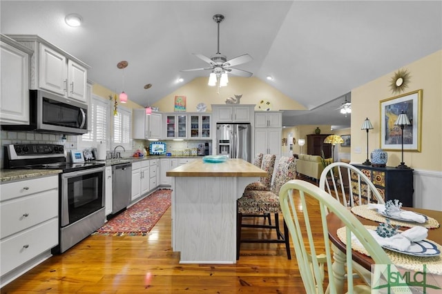 116 Brevard Ct, Savannah, GA 31410 - kitchen with stainless steel appliances, a ceiling fan, butcher block counters, a sink, and lofted ceiling