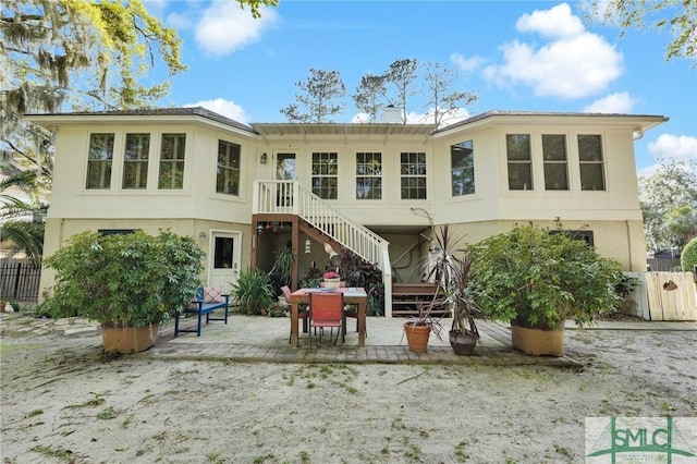 116 Brevard Ct, Savannah, GA 31410 - rear view of house featuring stucco siding, a patio area, and stairway