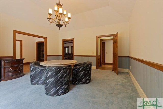 interior space with a wainscoted wall and a notable chandelier