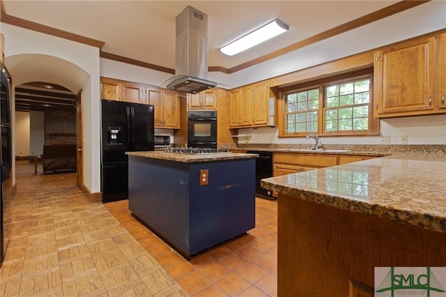 kitchen featuring island exhaust hood, ornamental molding, a center island, black appliances, and a sink