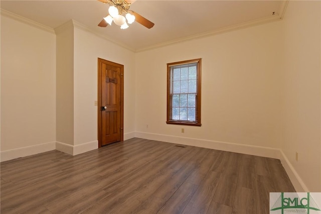 spare room with ornamental molding, ceiling fan, baseboards, and dark wood finished floors