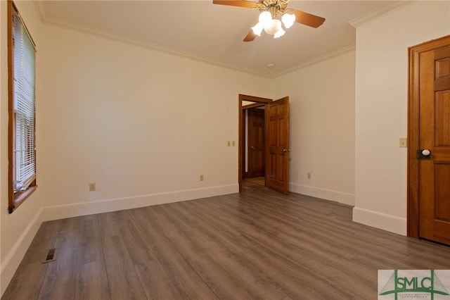 unfurnished room featuring ornamental molding, a ceiling fan, visible vents, and dark wood-style floors