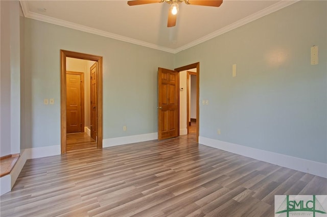 unfurnished room featuring ornamental molding, baseboards, a ceiling fan, and wood finished floors