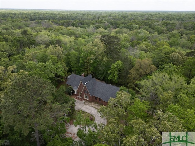birds eye view of property featuring a wooded view