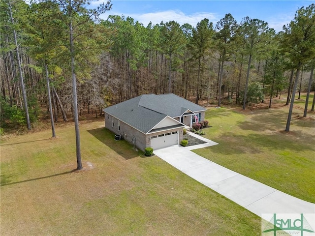 birds eye view of property with a forest view