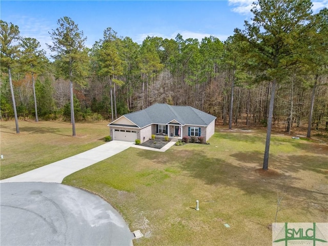 view of front of home with a view of trees, a garage, a front yard, and concrete driveway