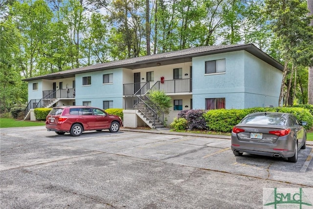12510 White Bluff Rd Unit 1406, Savannah, GA 31419 - view of building exterior with stairway and uncovered parking