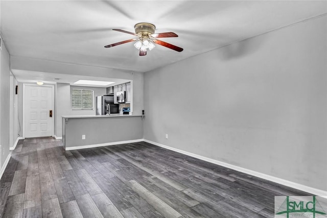 12510 White Bluff Rd Unit 1406, Savannah, GA 31419 - unfurnished living room with dark wood-style flooring, baseboards, and ceiling fan