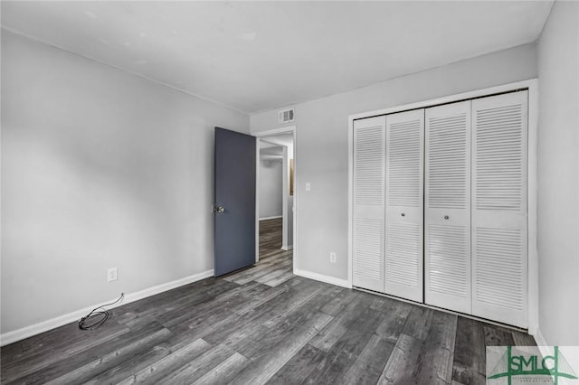 12510 White Bluff Rd Unit 1406, Savannah, GA 31419 - unfurnished bedroom with dark wood-style flooring, visible vents, baseboards, and a closet