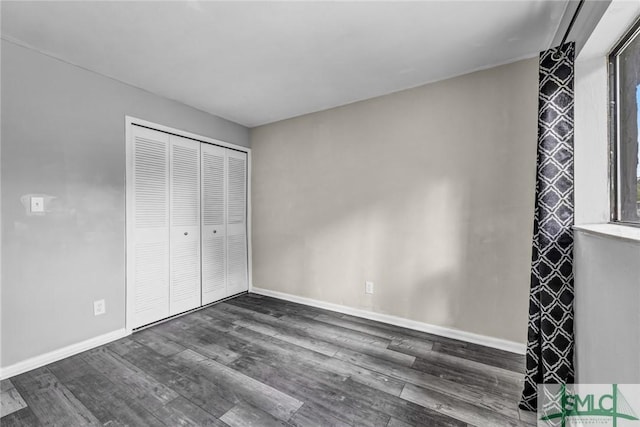 12510 White Bluff Rd Unit 1406, Savannah, GA 31419 - unfurnished bedroom featuring a closet, baseboards, and dark wood-style floors