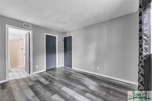 12510 White Bluff Rd Unit 1406, Savannah, GA 31419 - unfurnished bedroom featuring wood finished floors, ensuite bathroom, baseboards, and visible vents
