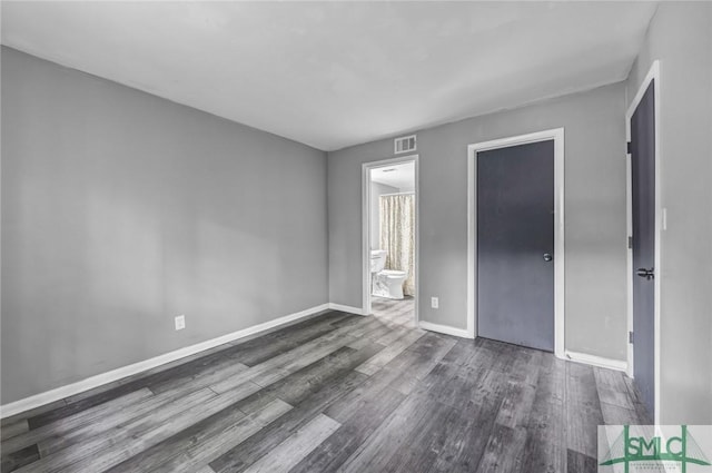 12510 White Bluff Rd Unit 1406, Savannah, GA 31419 - unfurnished bedroom featuring ensuite bath, visible vents, baseboards, and wood finished floors