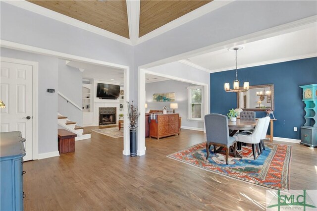 5 Wigmore Cir, Savannah, GA 31410 - dining room with a notable chandelier, a fireplace, stairway, crown molding, and wood finished floors