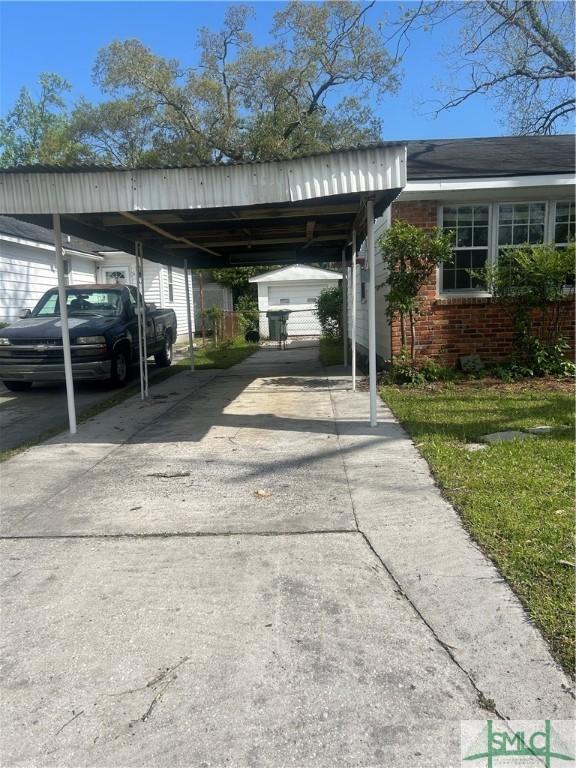 30 Lawton Ave, Savannah, GA 31404 - view of vehicle parking with a carport and driveway