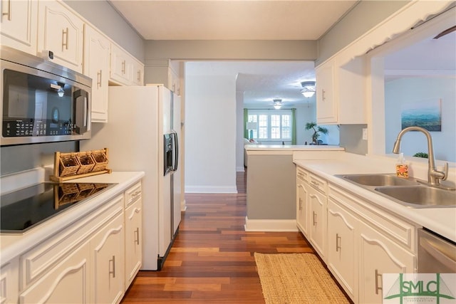 3411 Ponderosa Rd, Portal, GA 30450 - kitchen featuring a sink, light countertops, dark wood finished floors, white cabinetry, and stainless steel appliances