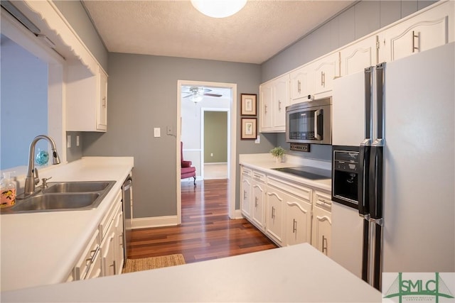 3411 Ponderosa Rd, Portal, GA 30450 - kitchen featuring baseboards, dark wood-style floors, a textured ceiling, appliances with stainless steel finishes, and a sink