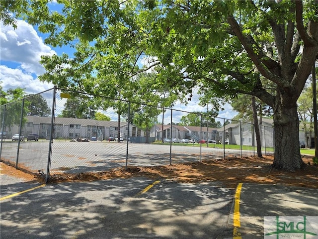 view of community featuring fence and a residential view