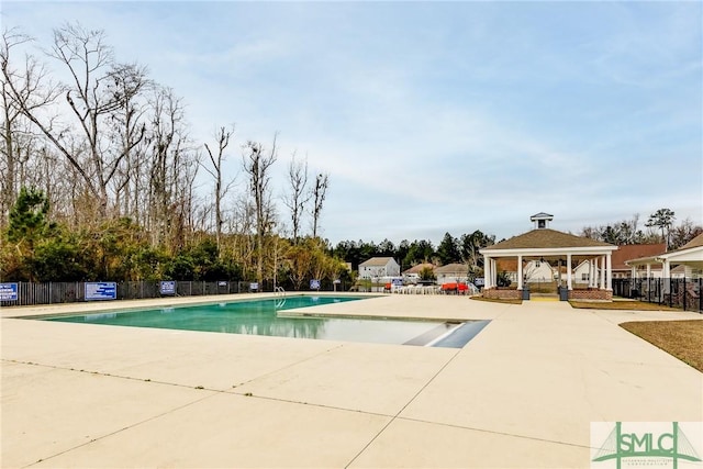 community pool featuring a gazebo, a patio area, and fence