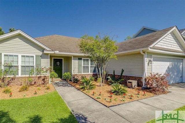 single story home featuring a shingled roof, a garage, and brick siding