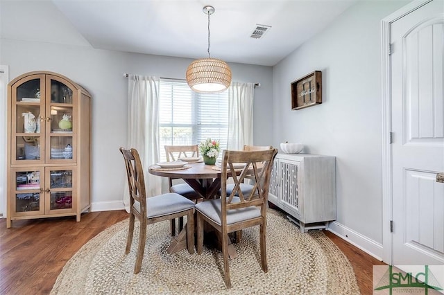 dining area featuring visible vents, baseboards, and wood finished floors