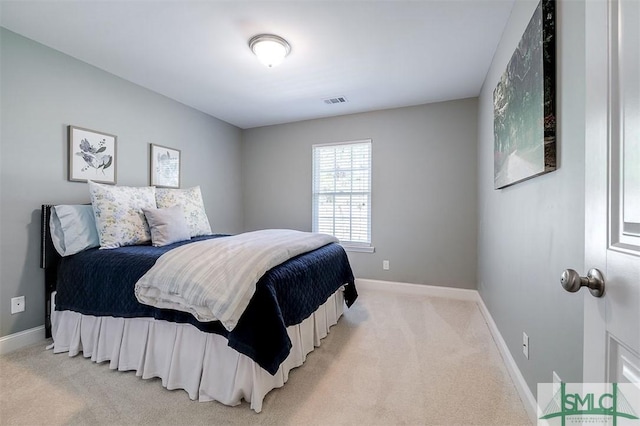 carpeted bedroom featuring baseboards and visible vents