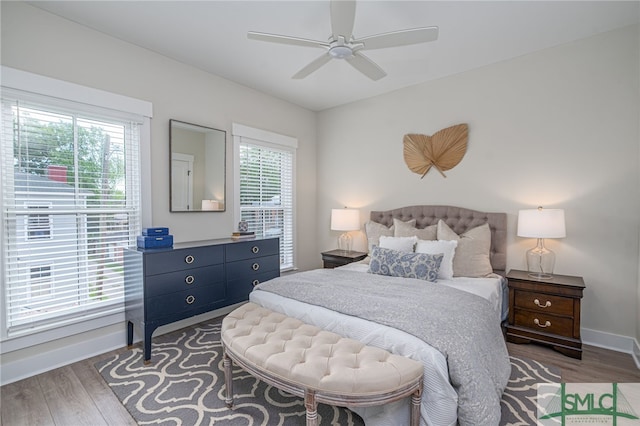 bedroom with wood finished floors, ceiling fan, and baseboards