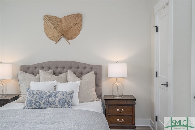 bedroom with baseboards and wood finished floors