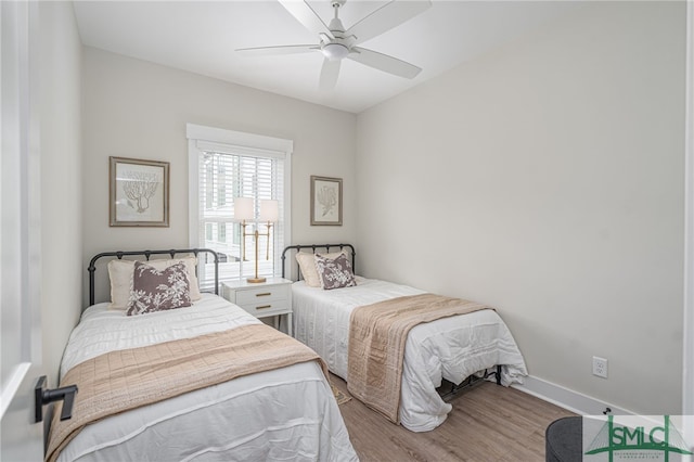 bedroom featuring baseboards, a ceiling fan, and wood finished floors